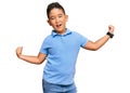 Little boy hispanic kid wearing casual clothes dancing happy and cheerful, smiling moving casual and confident listening to music Royalty Free Stock Photo