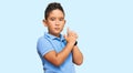 Little boy hispanic kid wearing casual clothes holding symbolic gun with hand gesture, playing killing shooting weapons, angry Royalty Free Stock Photo
