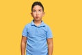 Little boy hispanic kid wearing casual clothes making fish face with lips, crazy and comical gesture Royalty Free Stock Photo