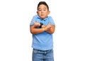 Little boy hispanic kid wearing casual clothes pointing to both sides with fingers, different direction disagree