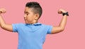 Little boy hispanic kid wearing casual clothes showing arms muscles smiling proud Royalty Free Stock Photo