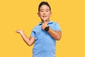 Little boy hispanic kid wearing casual clothes showing palm hand and doing ok gesture with thumbs up, smiling happy and cheerful Royalty Free Stock Photo