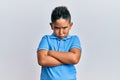 Little boy hispanic kid wearing casual clothes skeptic and nervous, disapproving expression on face with crossed arms Royalty Free Stock Photo