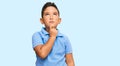 Little boy hispanic kid wearing casual clothes thinking concentrated about doubt with finger on chin and looking up wondering Royalty Free Stock Photo