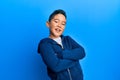 Little boy hispanic kid wearing casual sporty jacket happy face smiling with crossed arms looking at the camera Royalty Free Stock Photo