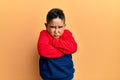 Little boy hispanic kid wearing casual sweatshirt skeptic and nervous, disapproving expression on face with crossed arms Royalty Free Stock Photo