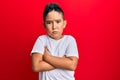 Little boy hispanic kid wearing casual white tshirt skeptic and nervous, disapproving expression on face with crossed arms Royalty Free Stock Photo