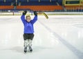 Little boy hockey player with full equipment and in blaue uniform on ice hockey rink. Sport for children Royalty Free Stock Photo