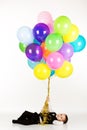 Little boy holding colorful balloons