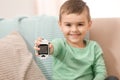 Little boy holding digital glucose meter at home, focus on hand. Royalty Free Stock Photo