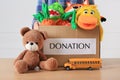 Little boy holding donation box with toys against white background, closeup Royalty Free Stock Photo