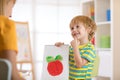 Little boy holding a drawing for mum Royalty Free Stock Photo