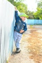 Little boy holding on fence outdoors Royalty Free Stock Photo