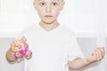 Little boy holding fidget spinner in hand closeup.