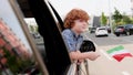 Little boy holding flag of Italy while looking out the car window. Trip, lifestyle concept. Royalty Free Stock Photo