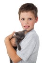 Little boy holding grey kitten smiling at camera Royalty Free Stock Photo
