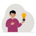 A little boy is holding a light bulb in his hand. Concept of idea, brainstorming, thinking, solution, eureka, bingo Royalty Free Stock Photo