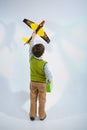 Little boy holding a plane model and handbag Royalty Free Stock Photo