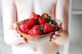 Little boy is holding a plate with red fresh strawberry Royalty Free Stock Photo