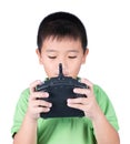 Little boy holding a radio remote control (controlling handset) for helicopter , drone or plane Isolated on white background Royalty Free Stock Photo