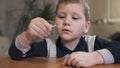 Boy holding a safety match and blowing into the flame. Slow motion