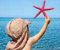 Little boy holding sea star Royalty Free Stock Photo