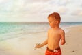 Little boy holding starfish on sunset beach Royalty Free Stock Photo