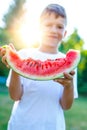 Little boy holding watermelon slice in sunset Royalty Free Stock Photo