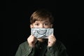 Little boy holds a chocolate bar in foil Royalty Free Stock Photo