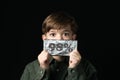 Little boy holds a chocolate bar in foil Royalty Free Stock Photo