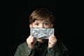 Little boy holds a chocolate bar in foil Royalty Free Stock Photo