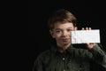 Little boy holds a chocolate bar in foil Royalty Free Stock Photo