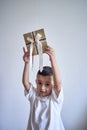 a little boy holds a craft gift certificate in his hands Royalty Free Stock Photo