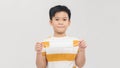 A little boy holds a medical mask on outstretched hands