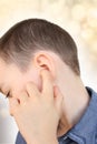 Little boy holds on to the ear, part of the face close-up, medical concept, hearing control, middle ear inflammation, otitis media Royalty Free Stock Photo