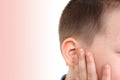 Little boy holds on to the ear, part of the face close-up, medical concept, hearing control, middle ear inflammation, otitis media Royalty Free Stock Photo