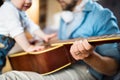 Little boy at home playing guitar with his father. Royalty Free Stock Photo