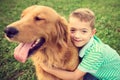 Little boy hugging his golden retriever pet dog Royalty Free Stock Photo