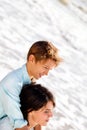 Little boy hugs his mother looking at the scenery seaside