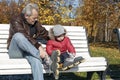 Little boy imitates his grandfather - he wears roller skates,