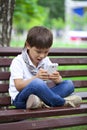 Little boy intently playing games on smartphone