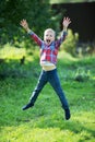 Little boy joyfully jumping in the summer