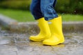 Little boy jumping in puddle of water at the summer or autumn day Royalty Free Stock Photo