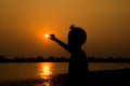 Little boy jumping before the sunset silhouette Royalty Free Stock Photo