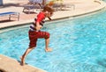 Little boy jumping into swimming pool