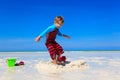 Little boy jumping on tropical beach