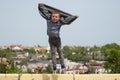 Little boy jumping up revealing jacket like wings