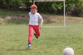 Little boy kicking ball in the park. playing soccer football in the park. Sports for exercise and activity Royalty Free Stock Photo