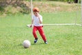 Little boy kicking ball in the park. playing soccer football in the park. Sports for exercise and activity Royalty Free Stock Photo