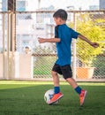 Little boy kicking a soccer ball in sport training session with motion blur and light effect Royalty Free Stock Photo